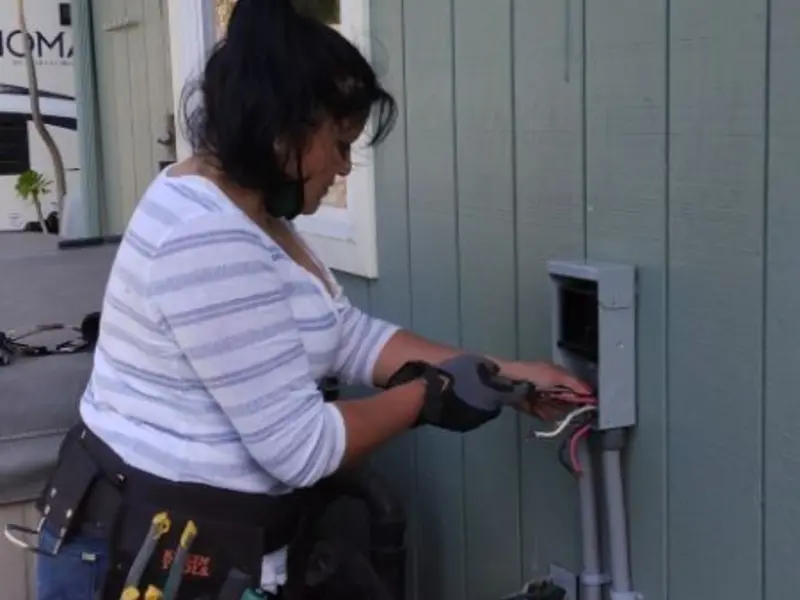 Licensed electrician wiring an exterior subpanel in Ocean City
